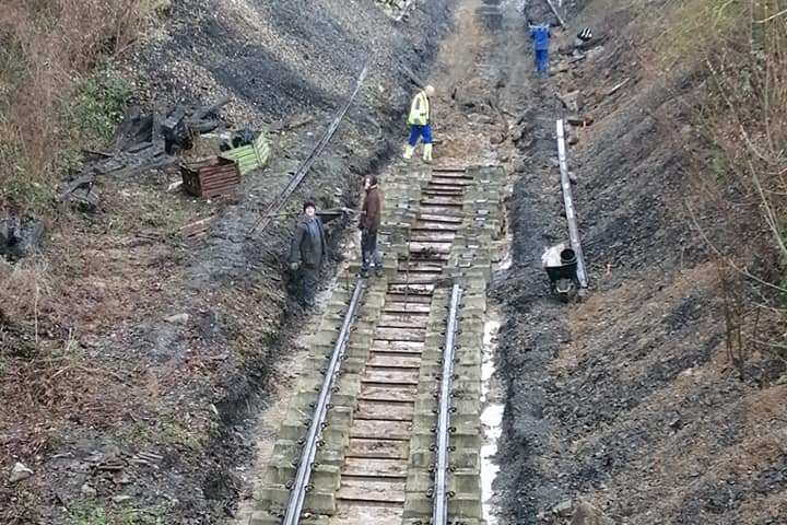 a train traveling down a dirt track