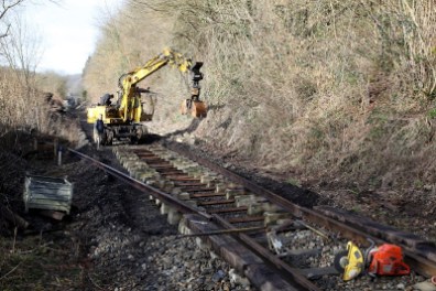 a train traveling down a dirt road