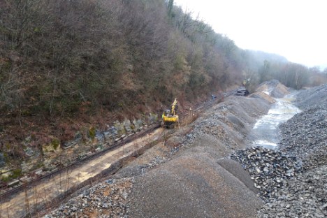a train traveling down a dirt track