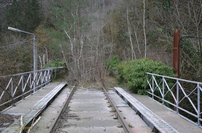 a bridge going over a wooden fence