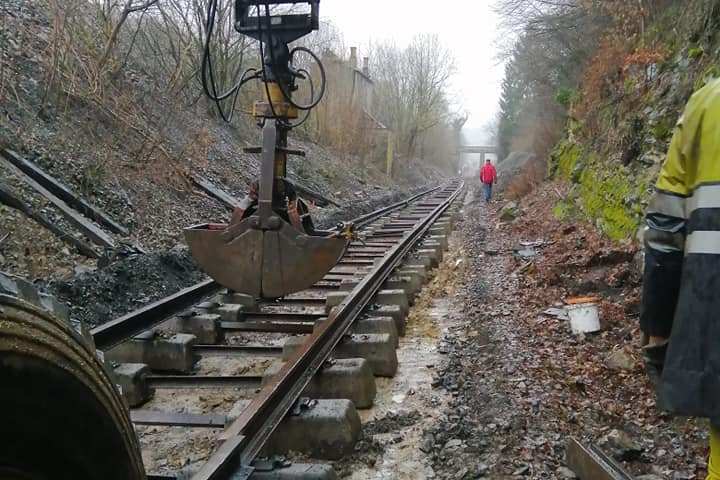 a train traveling down a dirt road