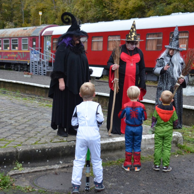 a group of people standing next to a train