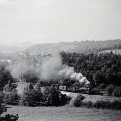 a steam train on a track with smoke coming out of it