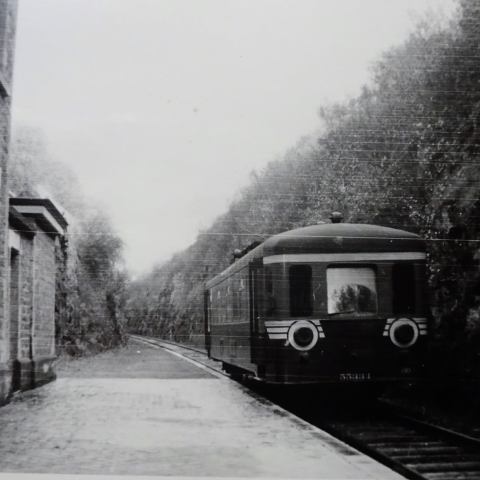 a train is coming down the street