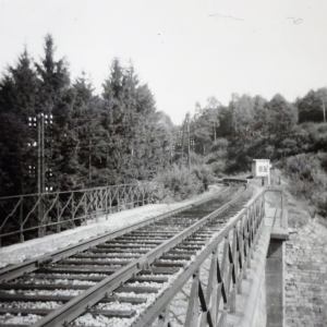 a train on a track near a fence