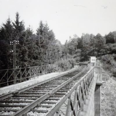a train on a track near a fence