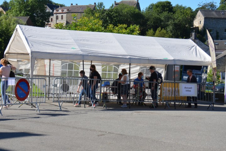 a group of people standing in a parking lot