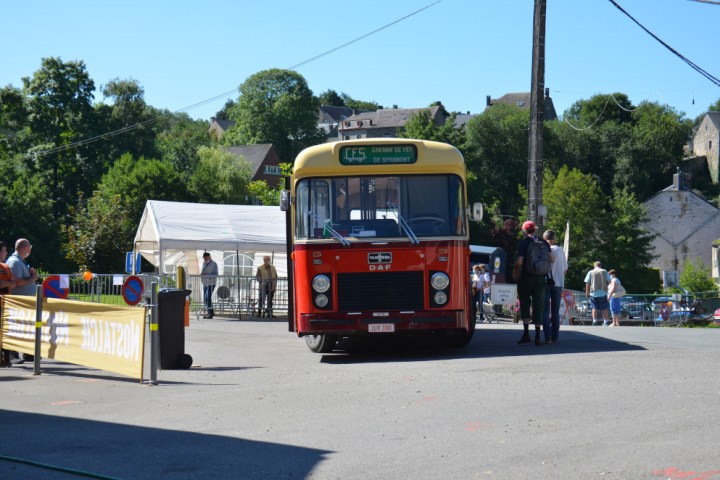 a passenger bus that is parked on the side of a road