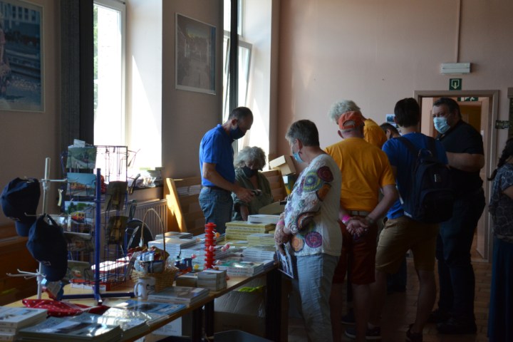 a group of people standing around a table