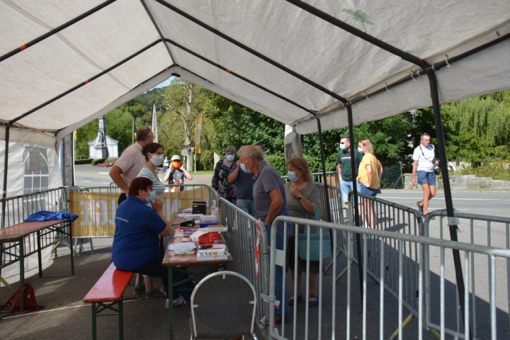 a group of people riding on top of a wooden fence