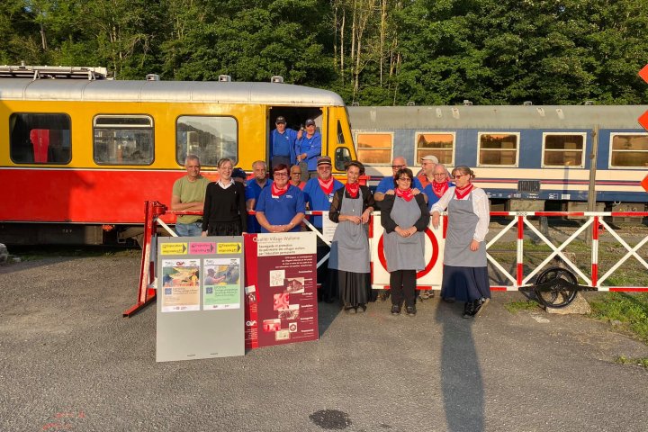 a group of people standing in front of a bus
