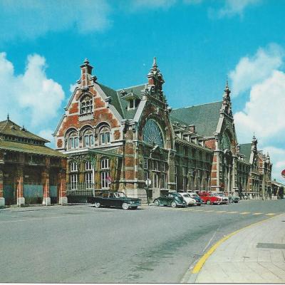 a large building with a clock on the side of a road