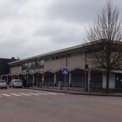 a building with a store on the corner of a street