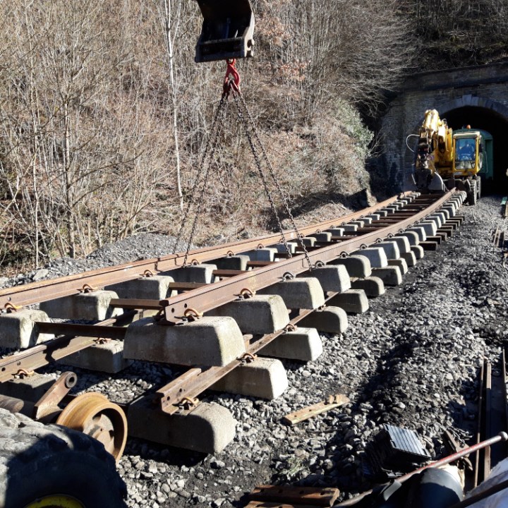 a group of people traveling down a dirt road