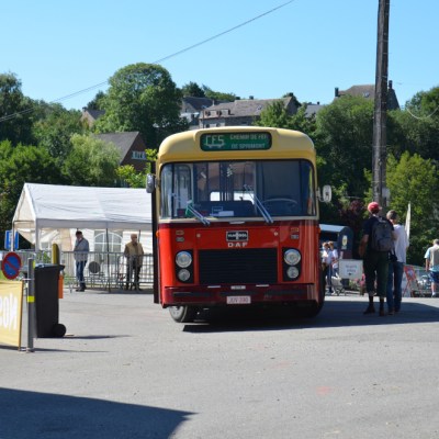 a passenger bus that is parked on the side of a road