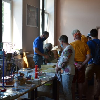 a group of people standing around a table
