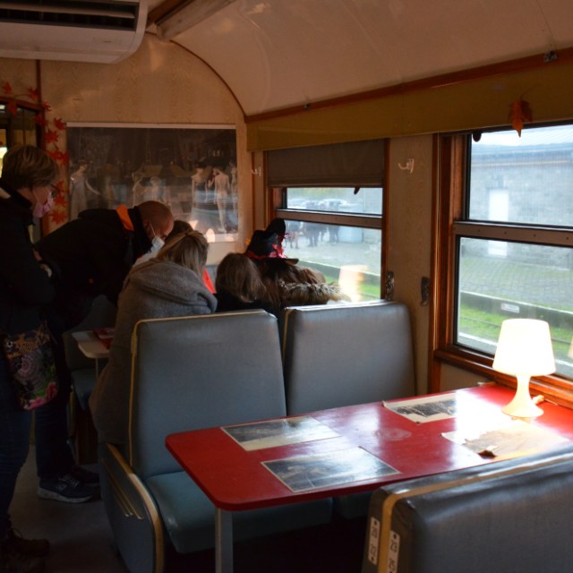 a group of people sitting at a table in front of a window