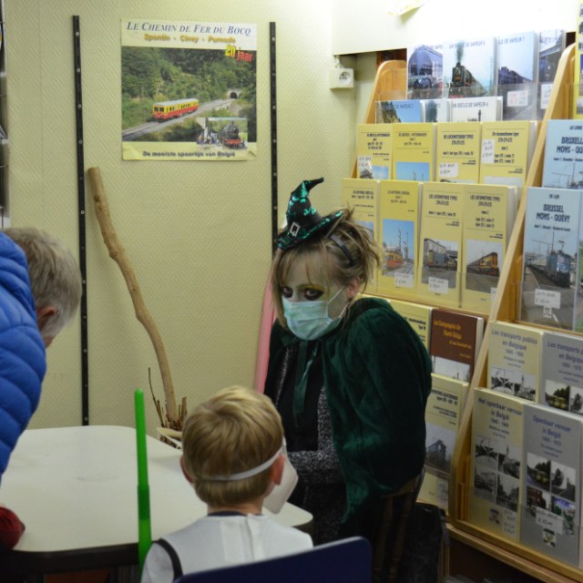 a boy standing in front of a store