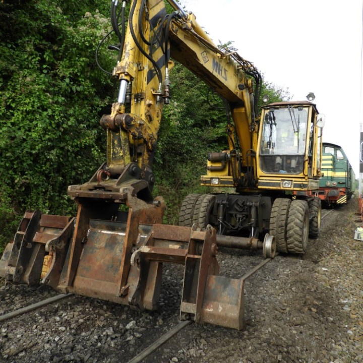 a truck driving down a dirt road