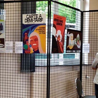 a couple of people that are standing in a cage