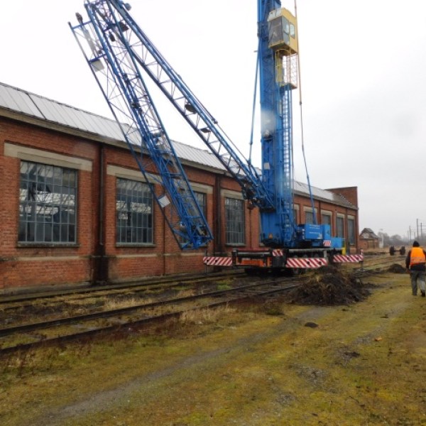 a crane next to a train