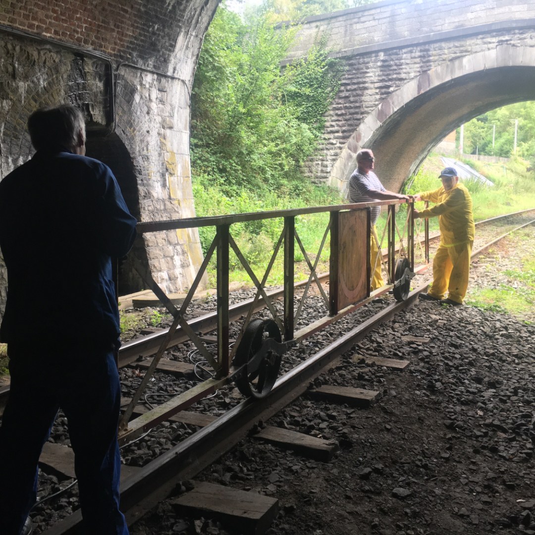 a man standing in front of a bridge