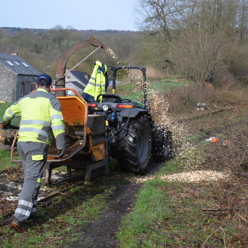 a man riding a motorcycle down a dirt road