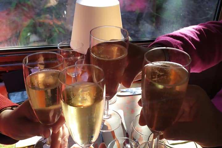 a person sitting at a table with wine glasses