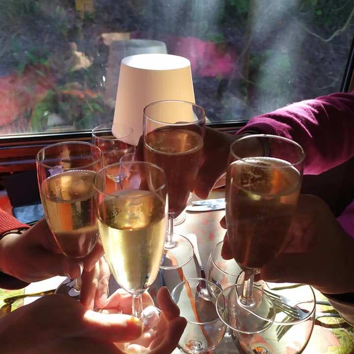 a person sitting at a table with wine glasses