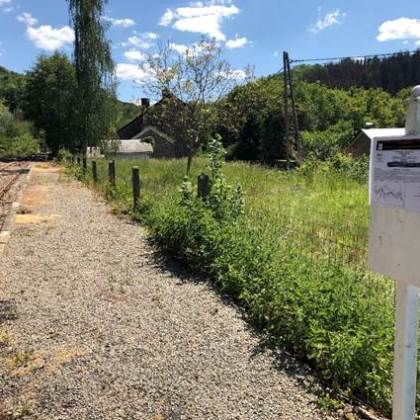 a sign on a dirt track