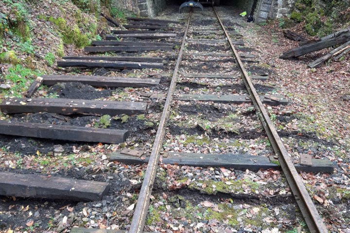 a tunnel in the middle of a park bench