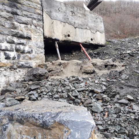 a pile of dirt in front of a building