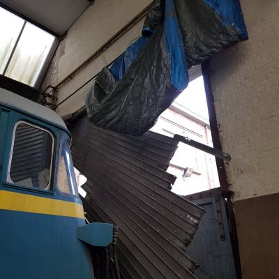 a train is parked on the side of a building