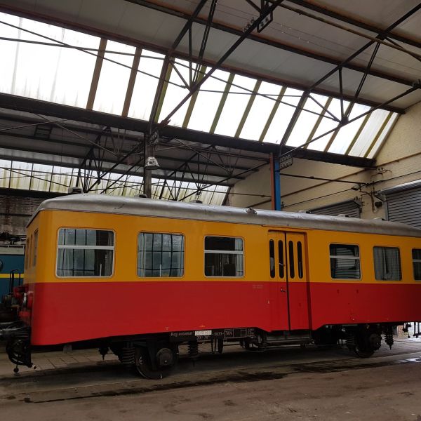 a train is parked on the side of a building