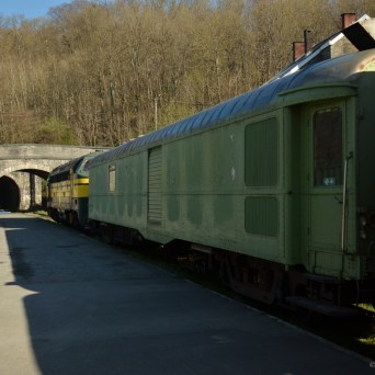 a train is parked on the side of the road