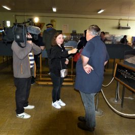 a group of people standing in a room playing a video game