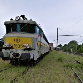 a train that is on top of a grass covered field