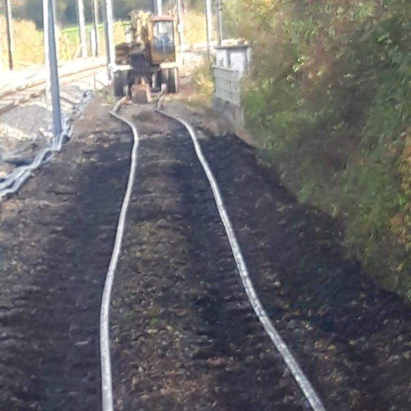 a train traveling down a dirt road