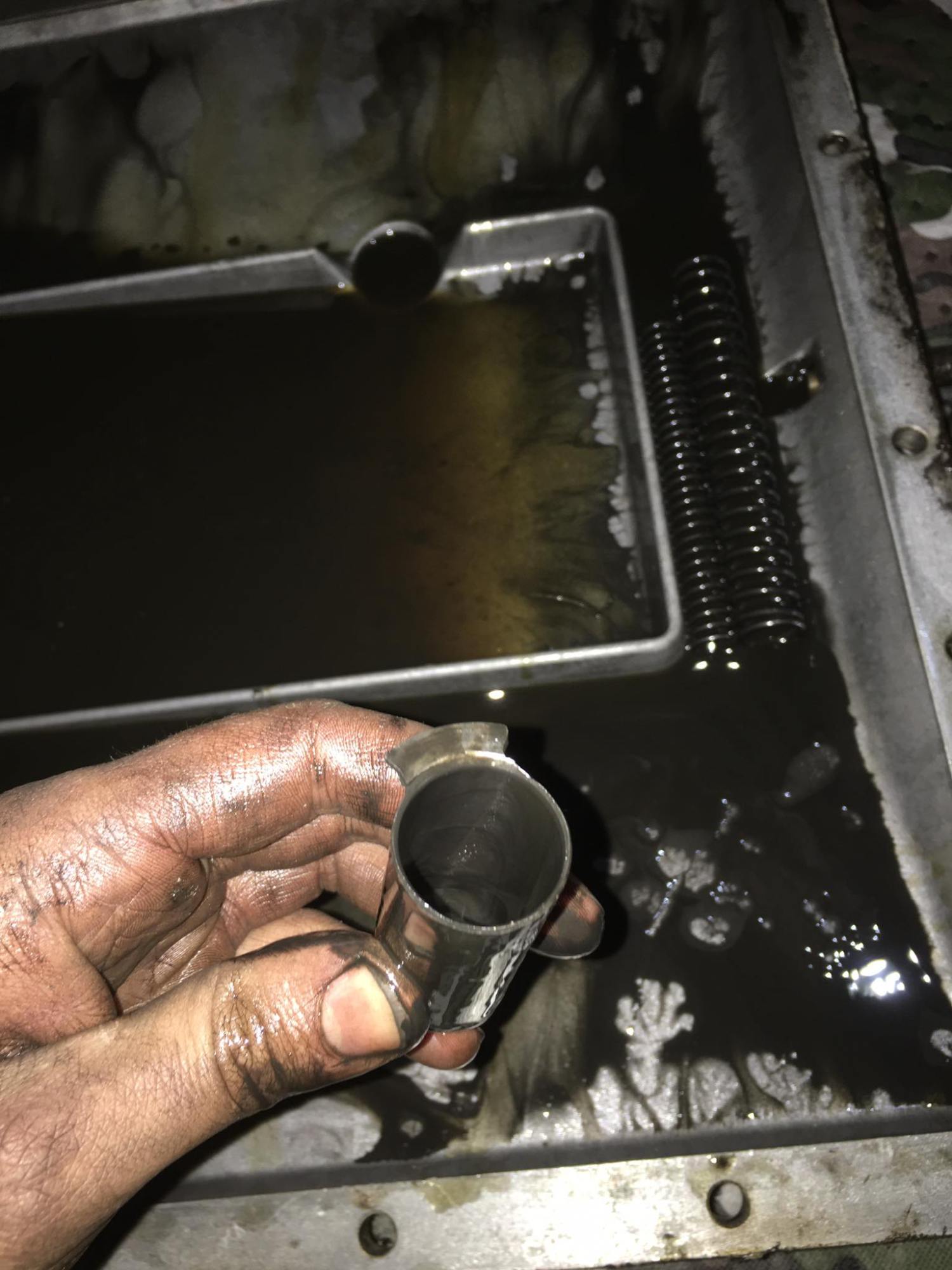 a close up of a person cutting a piece of metal pan