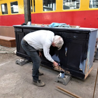 a person sitting on a sidewalk