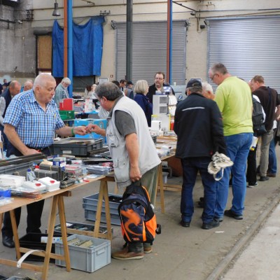 a group of people standing around a table