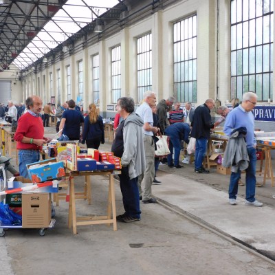 a group of people standing around a bag of luggage
