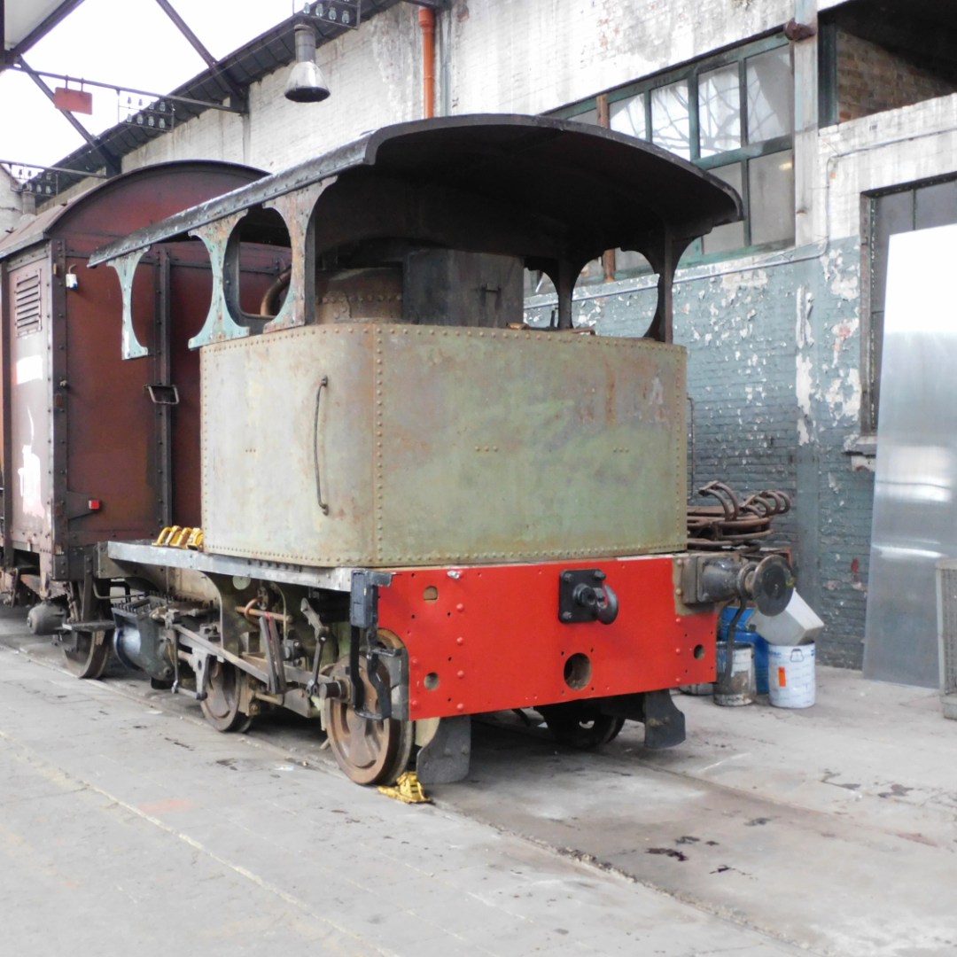 a train is parked on the side of a building