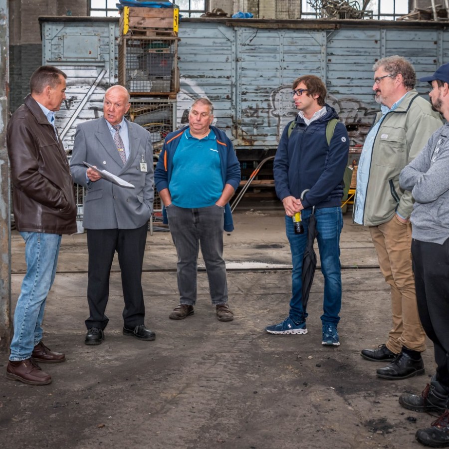 a group of people standing on a sidewalk