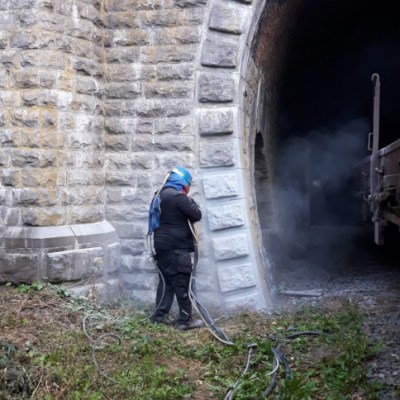 a person standing in front of a stone building