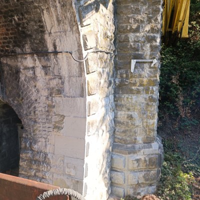 a stone building that has a brick wall