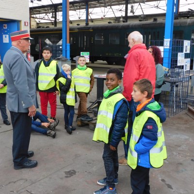a group of people standing next to a building