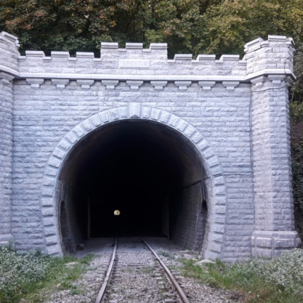 a stone path in front of a brick building