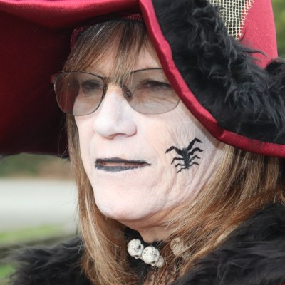 a close up of a person wearing a hat and sunglasses