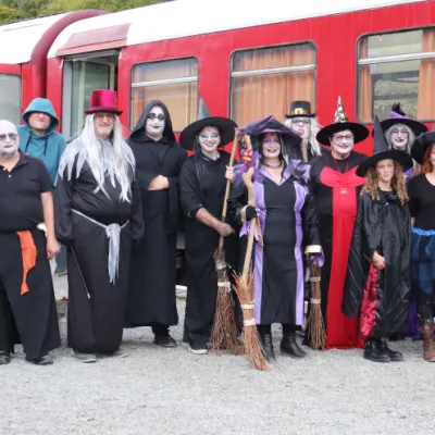 a group of people standing in front of a train